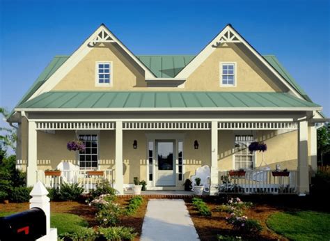 beige siding house with green metal roof|beige house with metal roof.